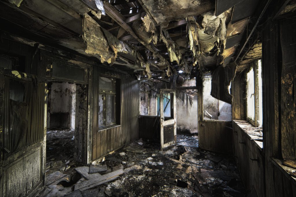 inside shot of an abandoned destroyed building with burned walls and worn out doors