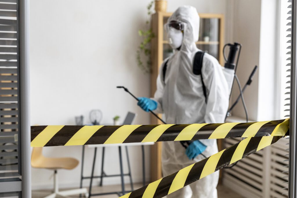 person disinfecting restricted area
